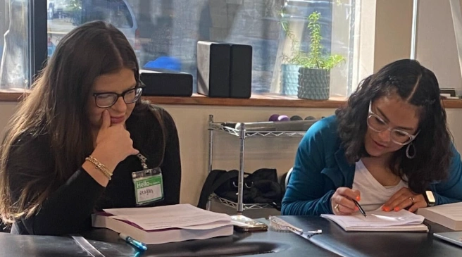 students reviewing workbook material